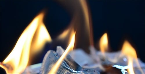 Flames Burning Tattered Cloth in a Close Up Shot
