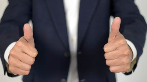 Torso in Suit Gives Thumbs Up Gesture
