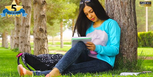 Young Woman Studying Outdoors in Park
