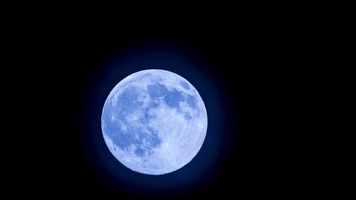 Blue Moon Rising in a Dark Night Sky