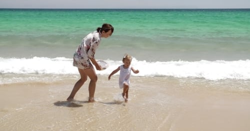 Young Mother With Her Daughter At The Sea