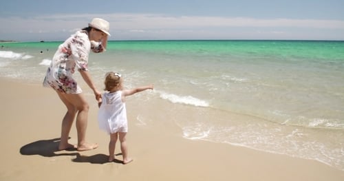 Mom With Her Little Girl Enjoying The Ocean View