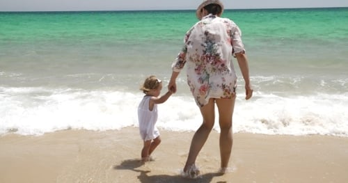 Mom And Daughter Bonding At The Beach On Summer
