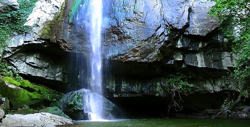 Waterfall Splashing into a Pond in a Forest