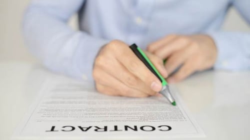 Person Highlights Contract with Green Marker Close Up
