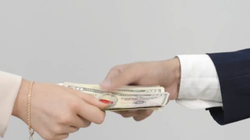 Money Exchange Between Two People in Close Up