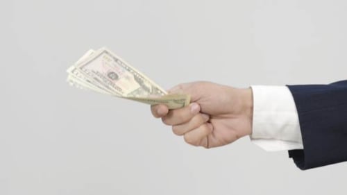 Business Hands Exchanging United States Currency
