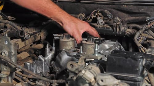 The Mechanic Checks the Car Parts Under the Hood. Close-up Shot in (UHD)