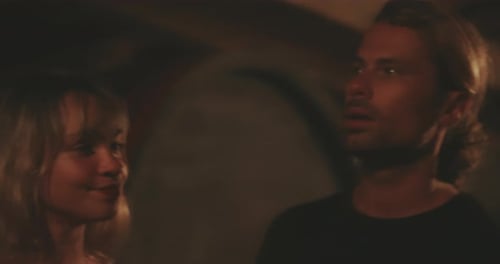 Group of Young Adults Talking Indoors at Night