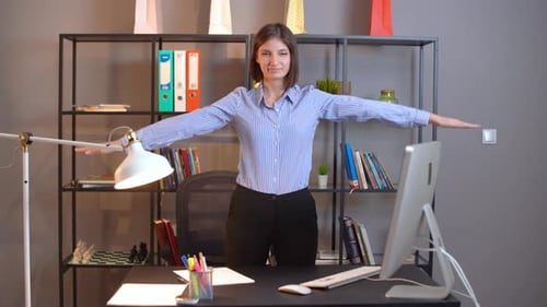 Woman Stretching Arms During Office Workday