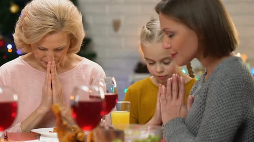 Female Family Members Praying Before Christmas Dinner, Christian Traditions