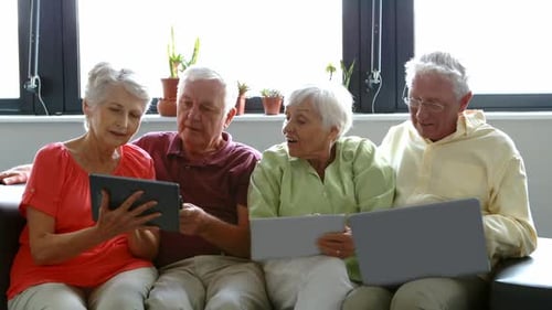 Seniors Using Modern Technology Together Indoors