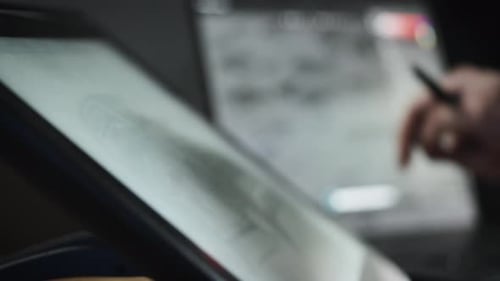 Hand Using Stylus to Draw on Tablet