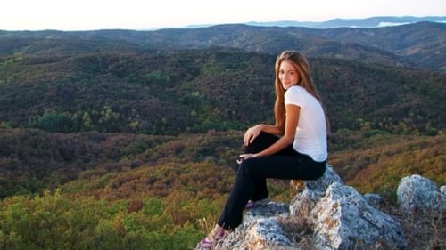 Pretty Model Sitting On The Rock