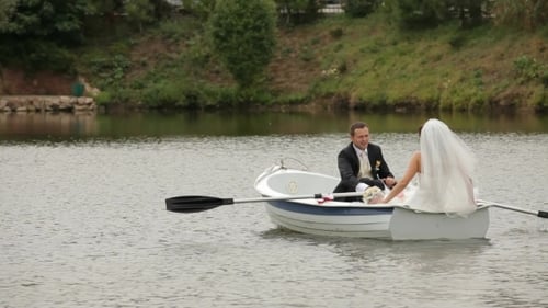 Bride and Groom on a Rowboat on a Lake