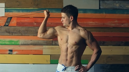 Muscular Man Bicep Curls Resistance Band