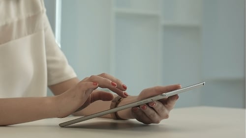 Woman Sitting In Office Table And Touch Tablet