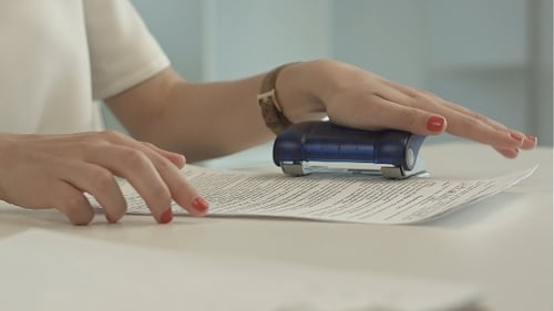 Woman Using a Hole Puncher