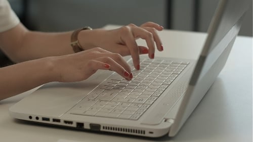 Woman Typing on White Laptop Keyboard Close Up