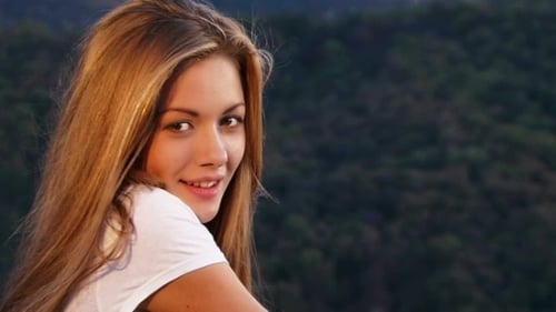 Smiling Woman Looking at Camera with Mountain Backdrop