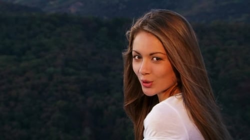 Smiling Woman Posing in Front of Mountain Backdrop