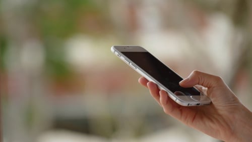Hand Using Silver Smartphone