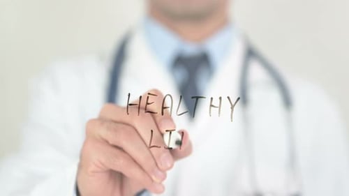 Doctor Writing Healthy Life on Glass