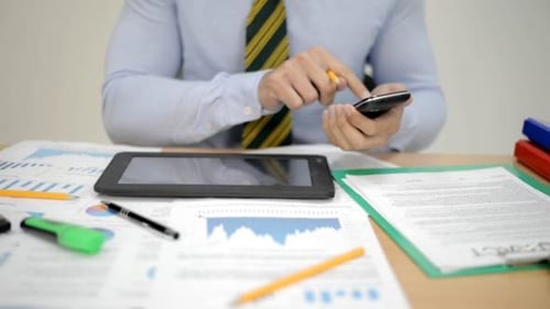 Man Typing on Smartphone in Office