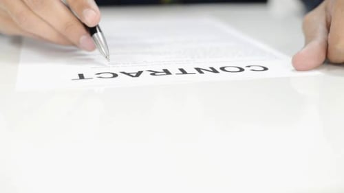 Close Up of Person Signing Contract