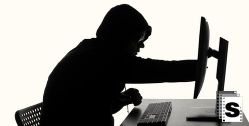 Silhouette of Hacker Typing on Computer Keyboard