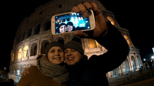 Couple Posing for Selfie in Front of Colosseum