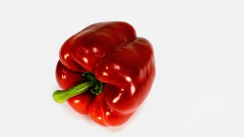 Glossy Red Pepper Rotating on White Background