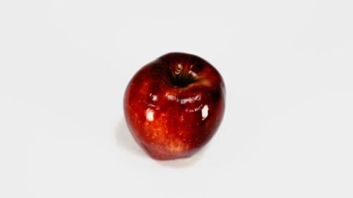 Fresh Red Apple in Close-Up on White