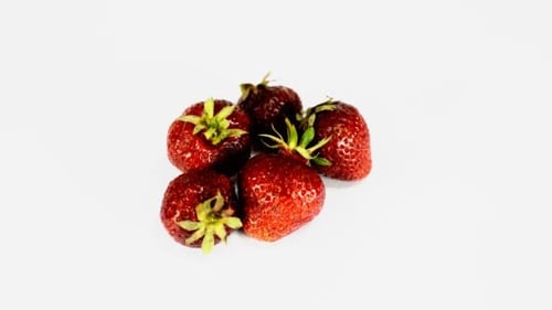 Red Strawberries with Green Stems on White Background