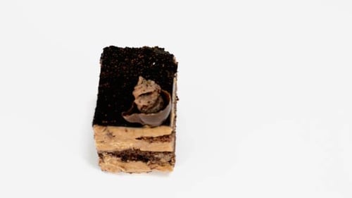 Delicious Chocolate Cake Slice Rotating on White Background