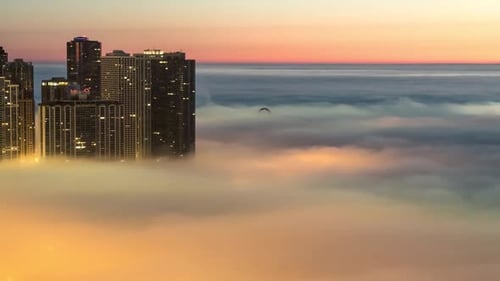 Fog Rolling Over Modern City at Sunrise