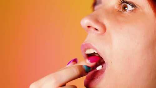 Woman Taking Pill and Drinking Water
