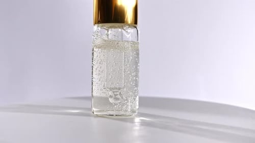 Clear Bottle with Bubbles on White Background