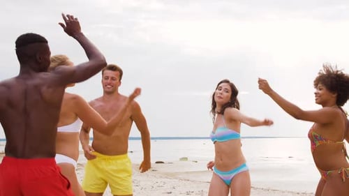 Happy Friends Dancing at Summer Beach Party
