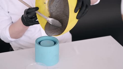 Crafting Grey Plaster in a Blue Container