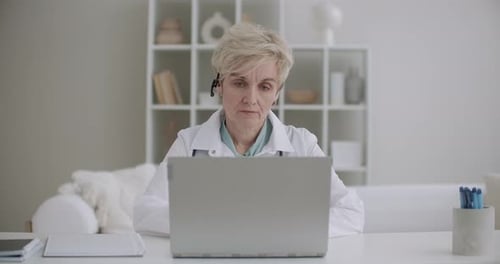 Female Doctor on Video Call Using Laptop