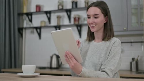 Woman using Tablet for Video Call at Home