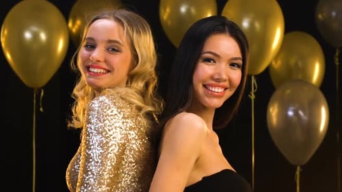 Two Beautiful Women Posing with Balloons at Party