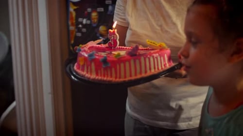Kids Blowing Out Birthday Candle with Mother