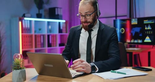 Man Celebrates Success in Colorful Office Environment