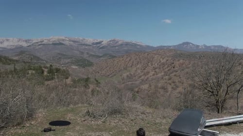 Couple of Tourist with Car Enjoy the Mountain Range Panorama Aerial Shot From Drone