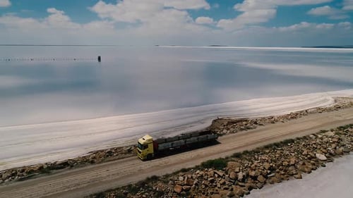 Truck Driving on Road Near the Water