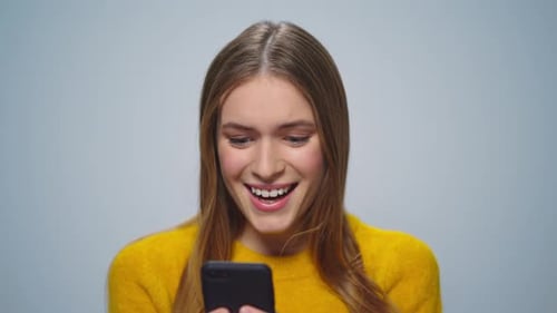 Excited Young Woman Reacting to Phone News