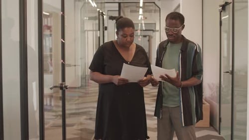 Coworkers Discussing Documents at Office