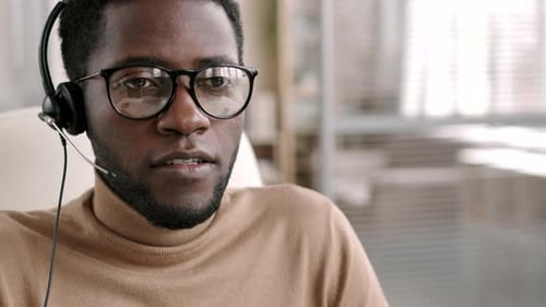 Young Adult Wearing Headset Speaking in Office